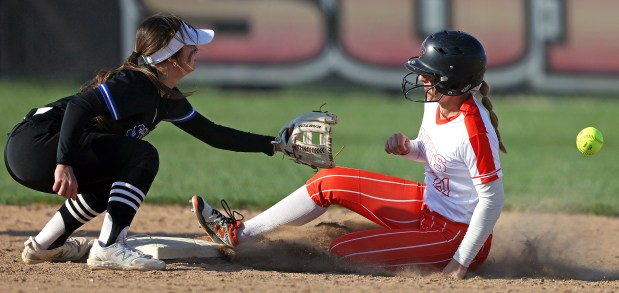 St. Charles East's Hayden Sujack (21) beats the throw to second as St. Charles North's Ginger Ritter (8) waits in the fourth inning during a DuKane Conference game in St. Charles on Friday, April 19, 2024. St. Charles East went on to win, 4-3.H. Rick Bamman / For the Beacon-News