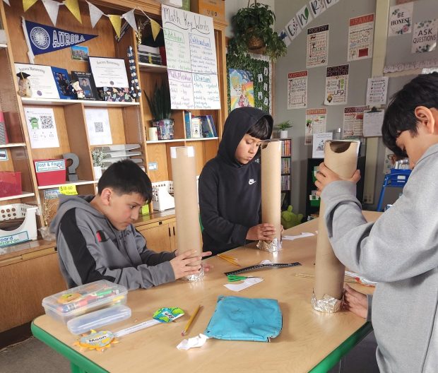 Students in Catherine Witzke's 4th grade class at Beaupre Elementary School in Aurora use cardboard tubes to make pinhole projectors for eclipse viewing (East Aurora School District 131)