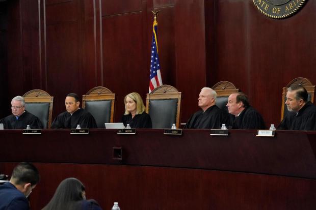 FILE - Arizona Supreme Court Justices from left; William G. Montgomery, John R Lopez IV, Vice Chief Justice Ann A. Scott Timmer, Chief Justice Robert M. Brutinel, Clint Bolick and James Beene listen to oral arguments on April 20, 2021, in Phoenix. The Arizona Supreme Court ruled Tuesday, April 9, 2024, that the state can enforce its long-dormant law criminalizing all abortions except when a mother's life is at stake. (AP Photo/Matt York, File)