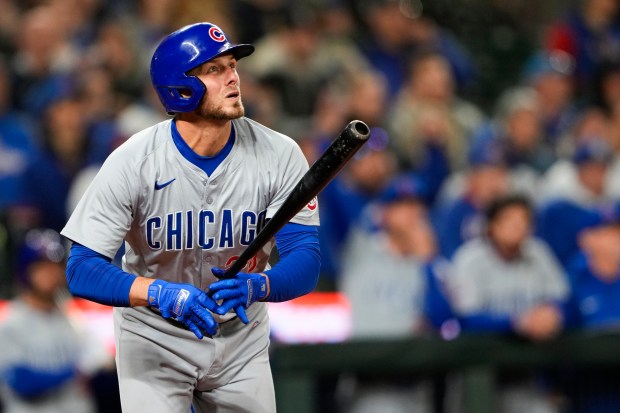 Cubs' Michael Busch follows through on a solo home run against the Mariners during the 9th inning on April 12, 2024, in Seattle. (AP Photo/Lindsey Wasson)