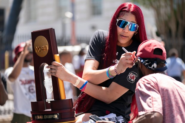 South Carolina's Kamilla Cardoso signs an autograph during the championship parade on April 14, 2024, in Columbia, S.C. (Sean Rayford/Getty Images)