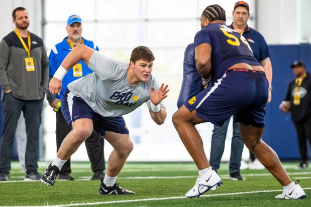 Offensive tackle Joe Alt, left, runs a drill against offensive tackle Blake Fisher, right, during Notre Dame pro day workouts in South Bend, Ind., on March 21, 2024. (AP Photo/Michael Caterina)