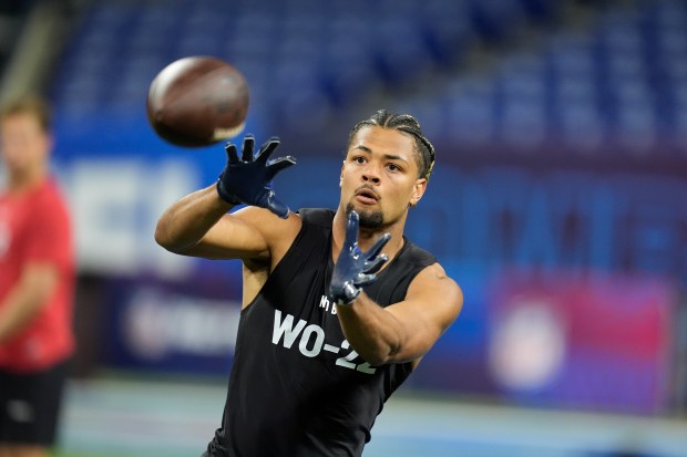 Washington wide receiver Rome Odunze runs a drill at the NFL combine on March 2, 2024, in Indianapolis. (AP Photo/Michael Conroy)