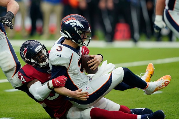 Broncos quarterback Drew Lock is sacked by Texans linebacker Jake Martin on Dec. 8, 2019, in Houston. (AP Photo/David J. Phillip)