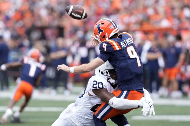 Penn State defensive end Adisa Isaac pressures Illinois quarterback Luke Altmyer on Sept. 16, 2023, in Champaign. (AP Photo/Charles Rex Arbogast)