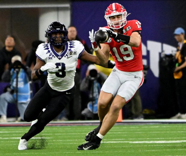 Brock Bowers #19 of the Georgia Bulldogs takes in a pass with Emari Demercado #3 of the TCU Horned Frogs defending in the first half the CFP National Championship Football game against the TCU Horned Frogs at SoFi  Stadium in Inglewood on Monday, Jan. 9, 2023. (Photo by Will Lester, Inland Valley Daily Bulletin/ SCNG)