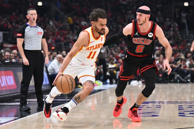 Trae Young of the Hawks drives against Alex Caruso of the Bulls in a play-in tournament game Wednesday, April 17, 2024, at the United Center. (Jamie Sabau/Getty Images)