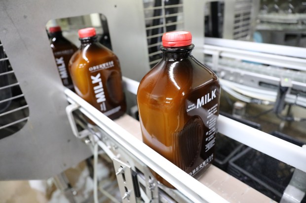 Amber glass bottles of white milk roll through the bottling assembly line at the Oberweis Dairy facility in North Aurora, Wednesday, March 1, 2017. Oberweis Dairy is changing their glass milk bottles displayed in grocery stores to amber glass. They believe that the amber glass will preserve the taste of the mil,.(Antonio Perez/ Chicago Tribune)