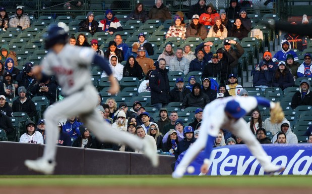 Fans watch as Cubs second baseman Nico Hoerner (2), right, reaches for an infield single hit by Houston Astros third baseman Alex Bregman, as Astros centerfielder Jake Meyers (6), left, advances to second base in the third inning at Wrigley Field on April 24, 2024, in Chicago. (John J. Kim/Chicago Tribune)