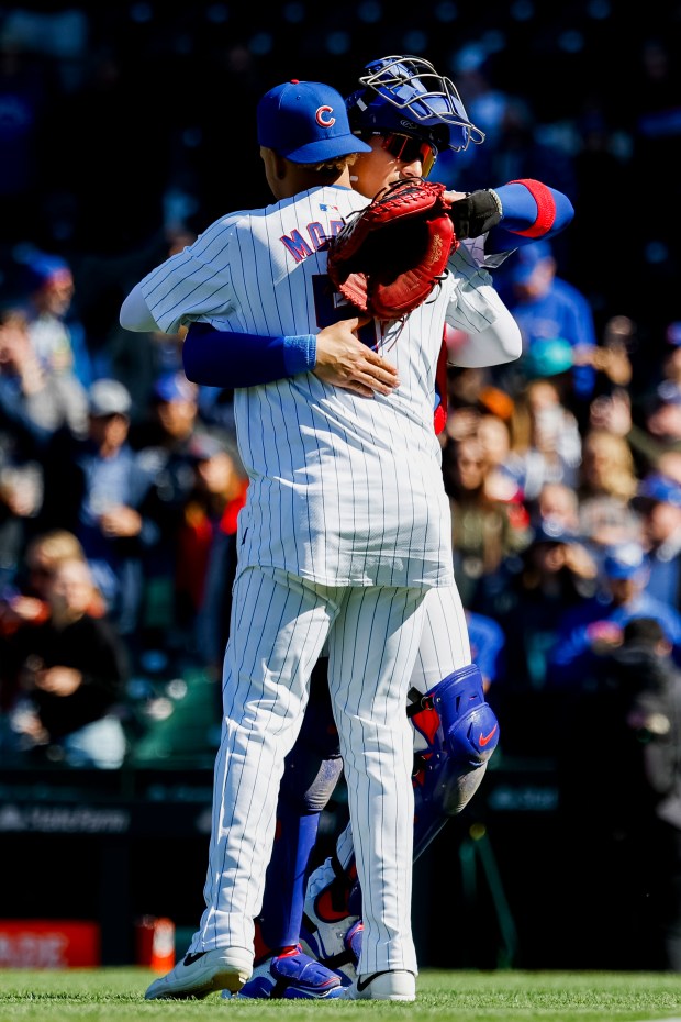Cubs designated hitter Christopher Morel (5) hugs catcher Miguel Amaya after an 8-3 win against the Marlins on April 19, 2024, at Wrigley Field. (Vincent Alban/Chicago Tribune)