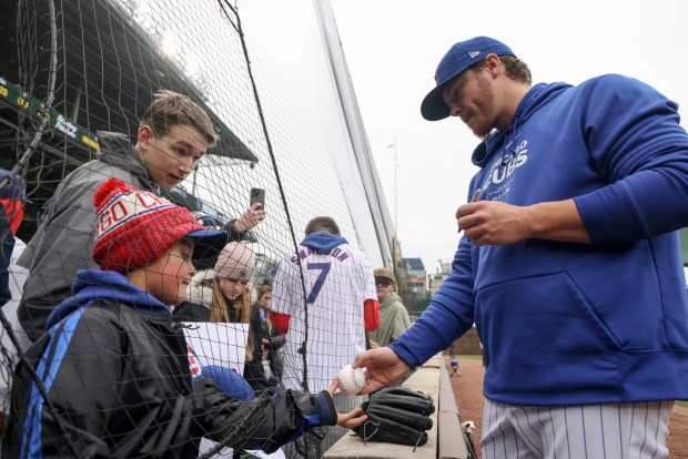 Chicago Cubs pitcher Justin Steele signs autographs for fans, April 1, 2024, before the home opener against the Colorado Rockies at Wrigley Field. (Brian Cassella/Chicago Tribune)