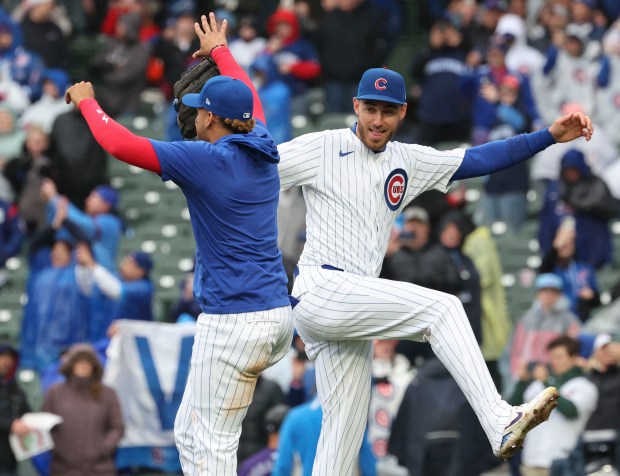 Chicago Cubs players Christopher Morel and Cody Bellinger celebrate the win Monday, April 1, 2024, in the home opener at Wrigley Field. (Brian Cassella/Chicago Tribune)