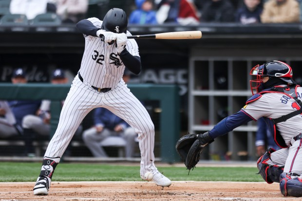 Chicago White Sox first baseman Gavin Sheets (32) gets hit by a pitch during the first inning of the game against the Atlanta Braves at Guaranteed Rate Field in Chicago on April 1, 2024. (Eileen T. Meslar/Chicago Tribune)