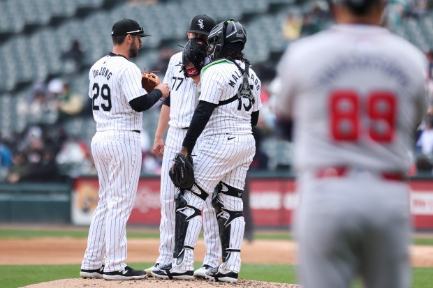 Chicago White Sox relief pitcher Chris Flexen (77) huddles with shortstop Paul DeJong (29) and catcher Martin Maldonado (15) during the third inning of the game against the Atlanta Braves at Guaranteed Rate Field in Chicago on April 1, 2024. (Eileen T. Meslar/Chicago Tribune)