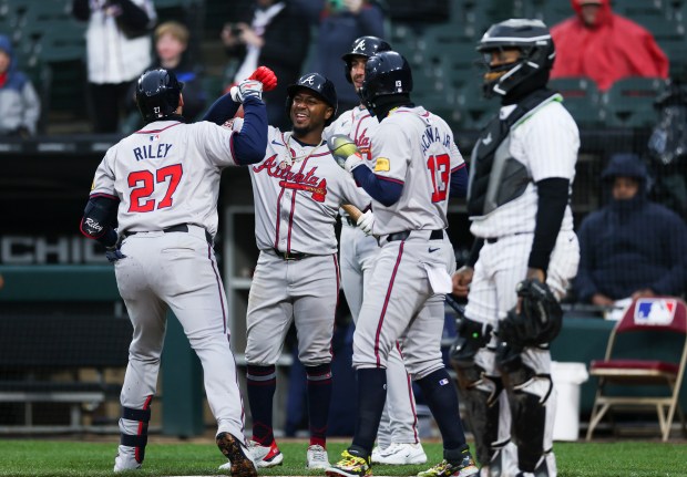 Atlanta Braves third baseman Austin Riley (27) celebrates his three-run home run with Atlanta Braves second baseman Ozzie Albies (1) and his other teammates during the eighth inning of the game against the Chicago White Sox at Guaranteed Rate Field in Chicago on April 1, 2024. (Eileen T. Meslar/Chicago Tribune)