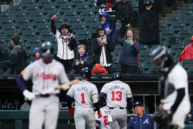Atlanta Braves fans celebrate after third baseman Austin Riley (27) scored a three-run home run during the eighth inning of the game against the Chicago White Sox at Guaranteed Rate Field in Chicago on April 1, 2024. (Eileen T. Meslar/Chicago Tribune)