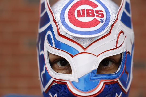 Cubs fan William Gonzalez poses for a portrait in a luchador mask outside Wrigley outside Wrigley Field ahead of the Chicago Cubs home opener against the Colorado Rockies on April 1, 2024. (Vincent Alban/Chicago Tribune)
