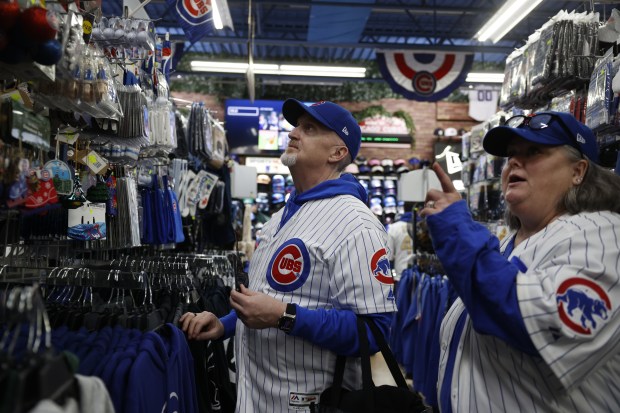 Cubs fans David Acke and Kristen Acke, both of Sacramento, California, shop at Sports World outside Wrigley Field ahead of the Chicago Cubs home opener against the Colorado Rockies on April 1, 2024. (Vincent Alban/Chicago Tribune)