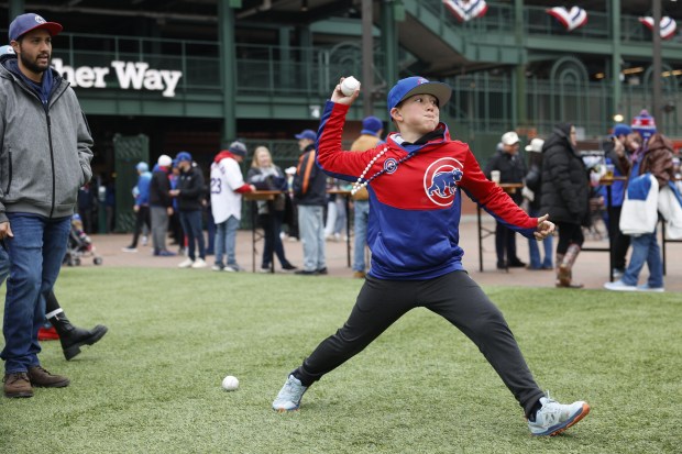 Landon Cooper, 9, of North Carolina, throws a ball outside Wrigley Field ahead of the Chicago Cubs home opener against the Colorado Rockies on April 1, 2024. (Vincent Alban/Chicago Tribune)