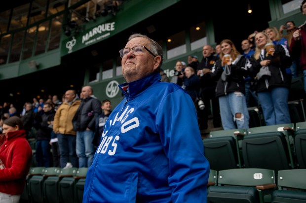 Mark Schwabero, of Naperville, watches the plane flyover before the home opening day game between the Chicago Cubs and the Colorado Rockies on April 1, 2024, at Wrigley Field. (Vincent Alban/Chicago Tribune)
