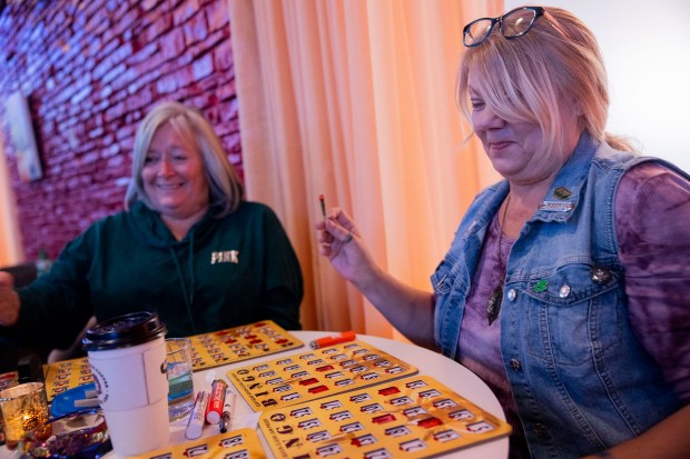 Julie Berggren, right, smokes marijuana alongside Debbie Gillette, left, during baked bingo night on April 9, 2024, at OKAY Cannabis Dispensary and West Town Bakery in Wheeling. (Vincent Alban/Chicago Tribune)