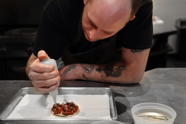 At his restaurant Cariño in Chicago, chef Norman Fenton makes a tostada on April 9, 2024. (Terrence Antonio James/Chicago Tribune)