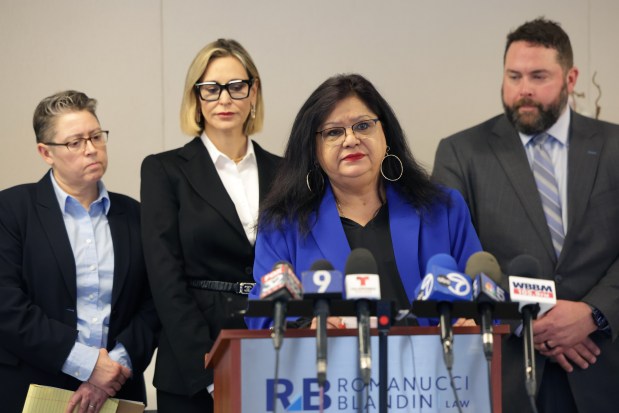 Ericka Matos, center-front, speaks about wanting justice for herself and others who contend Dr. Fabio Ortega sexually assaulted them during a press conference at Romanucci & Blandin Law office on Wednesday, April 3, 2024, in Chicago. Standing behind Matos are attorneys, left to right, Johanna Raimond, Tamara Holder, and Michael Holden. (Stacey Wescott/Chicago Tribune)