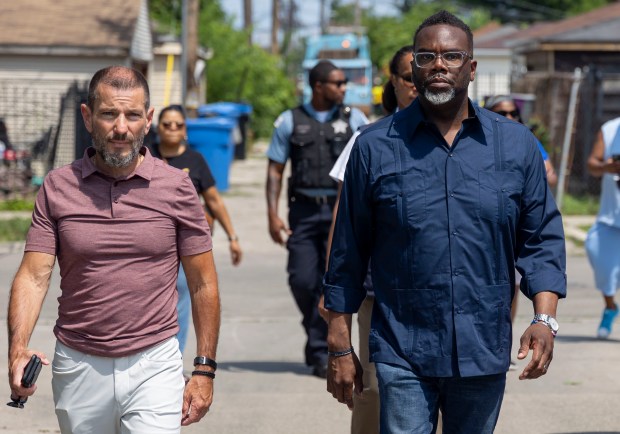 Mayor Brandon Johnson, right, visits the Austin neighborhood with chief of staff Rich Guidice on July 3, 2023, where flooding occurred. (Brian Cassella/Chicago Tribune)