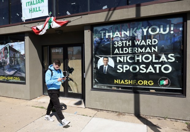 A man walks past the National Italian American Sports Hall of Fame under construction, with a thank you sign for Ald. Nicholas Sposato, 38th, at 3417 N. Harlem Ave., on April 19, 2024, in Chicago. (John J. Kim/Chicago Tribune)