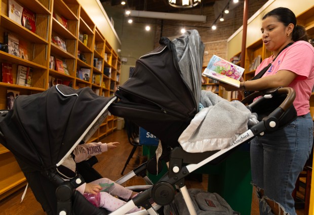 Nataly Marulanda and her two children Gohan, center, and Catalina, left, visit City Newsstand on April 15, 2024. (Stacey Wescott/Chicago Tribune)