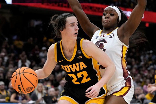Iowa guard Caitlin Clark drives around South Carolina guard Raven Johnson during the second half of the NCAA championship game Sunday, April 7, 2024, in Cleveland. (AP Photo/Morry Gash)