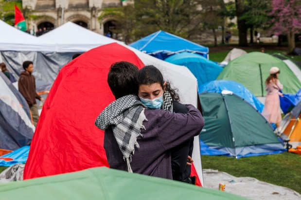 Activists hug after Northwestern University officials announced Monday that they have reached an agreement with students and faculty protesting against Israel-Hamas war, April 29, 2024, in Evanston. The deal comes five days after demonstrators established an encampment in Deering Meadow, a popular common area on the Evanston campus. (Armando L. Sanchez/Chicago Tribune)