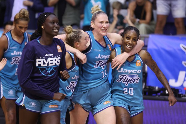 Nyadiew Puoch, from left, Rebecca Cole, Lauren Jackson and Jasmine Dickey of the Southside Flyers celebrate winning Game 3 of a WNBL semifinal series against the Melbourne Boomers on March 6, 2024, in Melbourne, Australia. (Daniel Pockett/Getty Images)