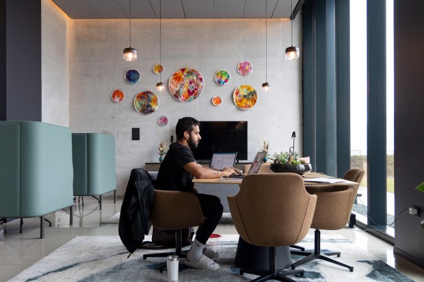 A resident works in a shared study room at The Reed, a new condominium and rental building in the South Loop on April 2, 2024. (Brian Cassella/Chicago Tribune)