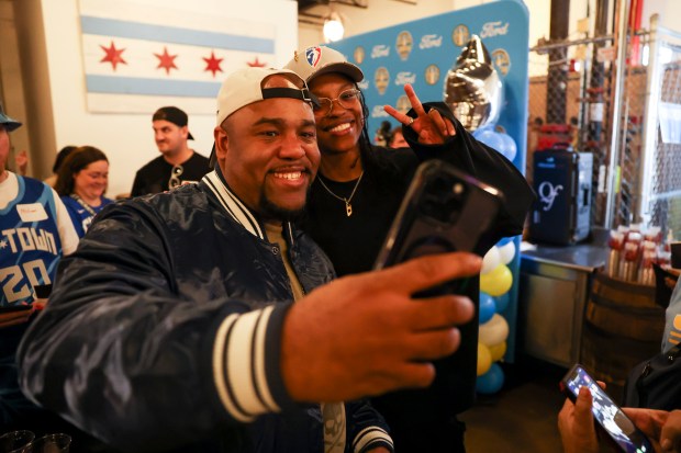 Season ticket holder Andre Pope poses for a photo with Chicago Sky player Diamond DeShields during Chicago Sky's WNBA draft watch party at Revolution Brewing in Chicago on April 15, 2024. (Eileen T. Meslar/Chicago Tribune)