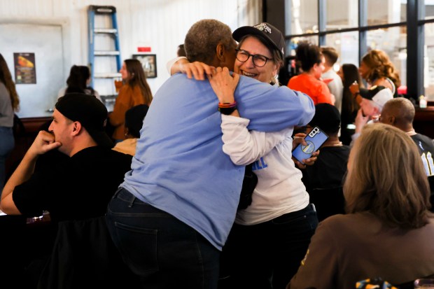 Vada Woods hugs Michele Curley in celebration after Kamilla Cardoso was picked third in the draft by the Chicago Sky during Chicago Sky's WNBA draft watch party at Revolution Brewing in Chicago on April 15, 2024. (Eileen T. Meslar/Chicago Tribune)