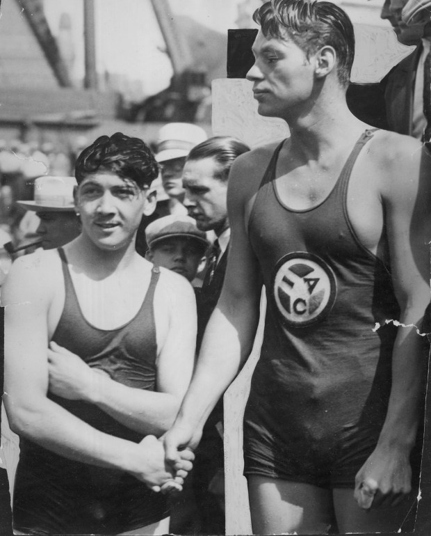 Johnny Weissmuller, right, broke a record in the annual swim race in 1927 in the Chicago River, beating Sol Adler, left, who came in second. (Chicago Tribune historical photo)