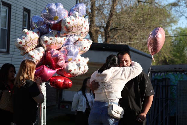 Jose Molina, right, is consoled before the start of a prayer vigil for his slain daughter Ariana Molina in the 2000 block of West 52nd Street in Chicago on Monday, April 15, 2024. A shooting over the weekend claimed the life of 9-year-old Ariana Molina. (Terrence Antonio James/Chicago Tribune)