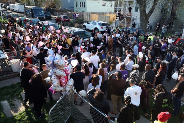 People attend a prayer vigil in the 2000 block of W. 52nd Street in Chicago on April 15, 2024, after a mass shooting over the weekend that claimed the life of 9-year-old Ariana Molina. (Terrence Antonio James/Chicago Tribune)