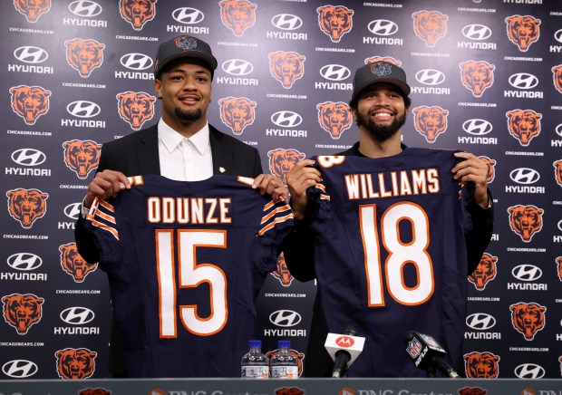 New Bears wide receiver Rome Odunze and quarterback Caleb Williams pose for photographs at Halas Hall on April 26, 2024. (Chris Sweda/Chicago Tribune)