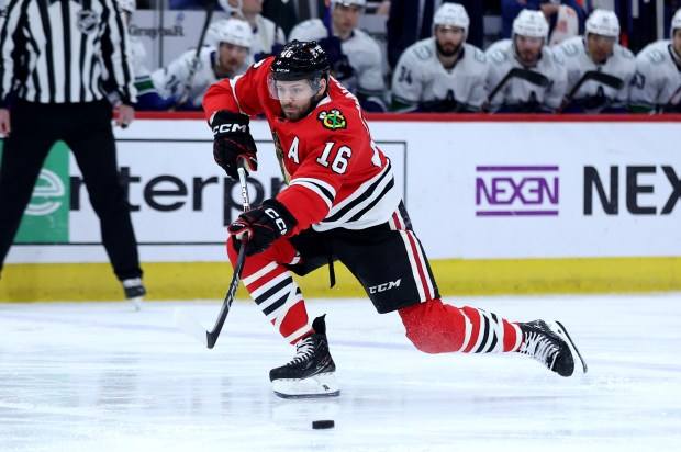 Chicago Blackhawks center Jason Dickinson (16) makes a pass in the first period of a game against the Vancouver Canucks at the United Center in Chicago on Feb. 13, 2024. (Chris Sweda/Chicago Tribune)