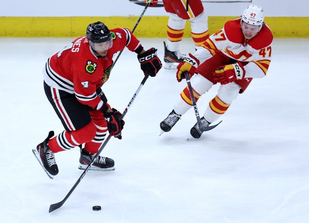 Blackhawks defenseman Seth Jones looks to pass against the Flames on March 26, 2024, at the United Center. (Chris Sweda/Chicago Tribune)