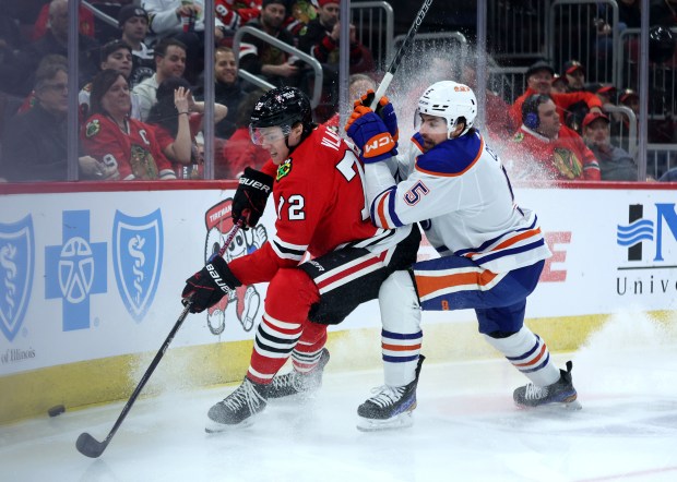 Chicago Blackhawks defenseman Alex Vlasic (72) and Edmonton Oilers defenseman Cody Ceci (5) battle in the first period of a game at the United Center in Chicago on Jan. 9, 2024. (Chris Sweda/Chicago Tribune)