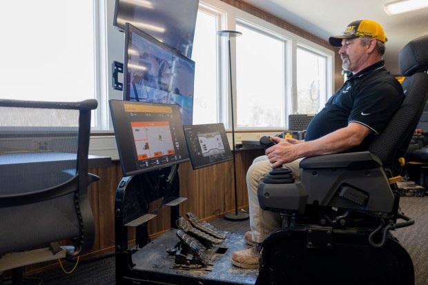 Tim Pennington, a remote test operator, operates a D7 bulldozer remotely while the bulldozer is outside on Wednesday, March 27, 2024, at the Caterpillar Proving Grounds in Washington, Ill. (Vincent Alban/Chicago Tribune)