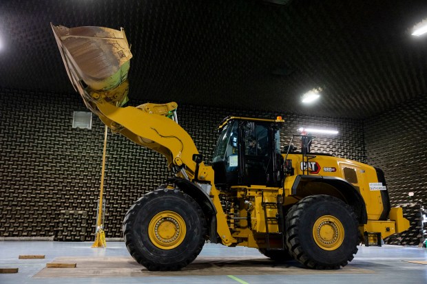 Colin Mitchell, in driver's seat, a senior associate of testing and validation, lifts the bucket on the 980XE medium wheel loader on Wednesday, March 27, 2024, at the Caterpillar Proving Grounds in Washington, Ill. (Vincent Alban/Chicago Tribune)