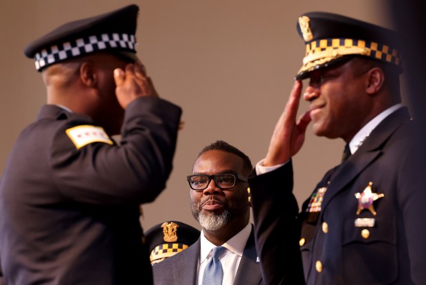 Mayor Brandon Johnson watches as police Superintendent Larry Snelling, right, salutes and congratulates recruits during the Chicago Police Department's recruit class graduation and promotion ceremony at Navy Pier, March 11, 2024. (Antonio Perez/Chicago Tribune)