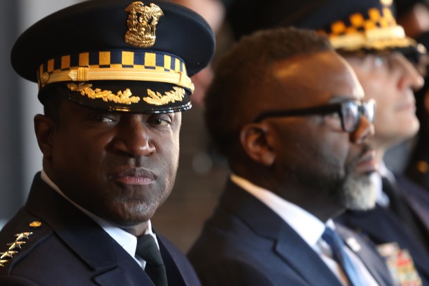 Police Superintendent Larry Snelling, left, and Mayor Brandon Johnson pose for group photos with recruits before the start of the Chicago Police Department recruit class graduation and promotion ceremony at Navy Pier on March 11, 2024. (Antonio Perez/Chicago Tribune)