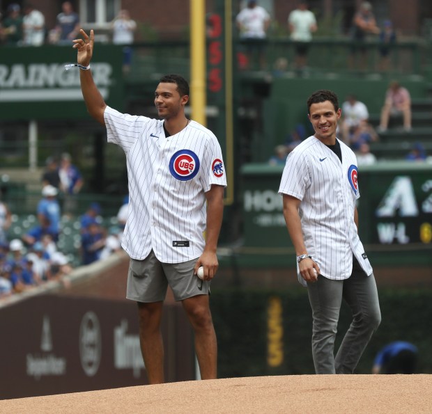 Chicago Blackhawks players Seth Jones, left, and Caleb Jones take the mound to throw ceremonial first pitches for a game between the Chicago Cubs and Arizona Diamondbacks at Wrigley Field Saturday, July 24, 2021, in Chicago. (John J. Kim/Chicago Tribune)