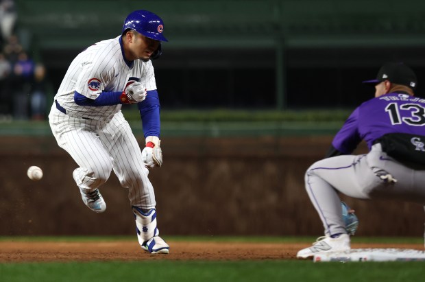 Chicago Cubs right fielder Seiya Suzuki (27) tries to get back to first base before being tagged out by Colorado Rockies second baseman Alan Trejo after Suzuki was caught between first and second following a 2-run single in the second inning of a game at Wrigley Field in Chicago on Wednesday, April 3, 2024. (Chris Sweda/Chicago Tribune)