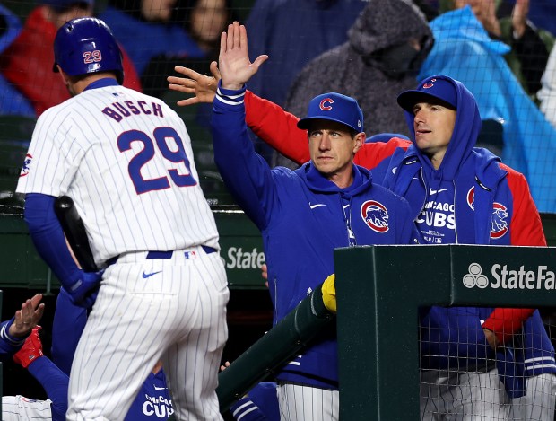 Cubs manager Craig Counsell celebrates after a sacrifice fly by first baseman Michael Busch (29) in the second inning against the Rockies on Wednesday, April 3, 2024, at Wrigley Field. (Chris Sweda/Chicago Tribune)